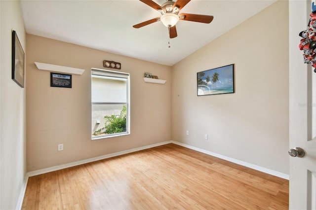 empty room featuring ceiling fan, lofted ceiling, and light wood-type flooring