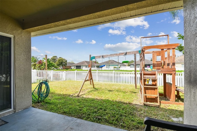 6843 Runner Oak Dr, Wesley Chapel, FL 33545 - view of yard with a patio, a fenced backyard, a residential view, a water view, and a playground