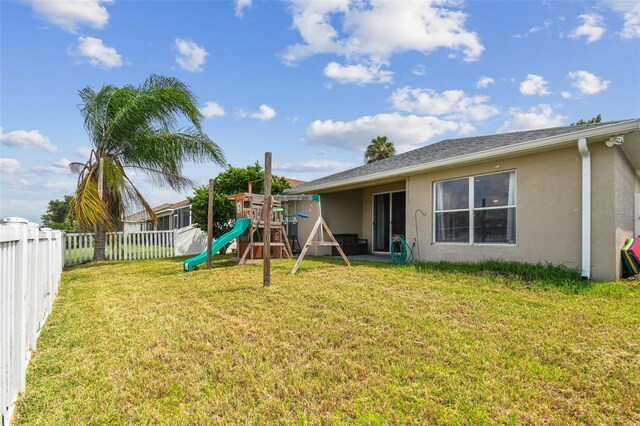 exterior space featuring a playground and a yard