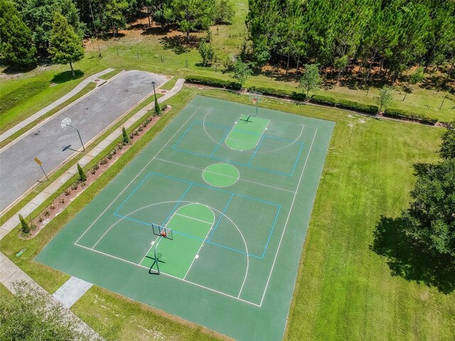 view of basketball court featuring a lawn