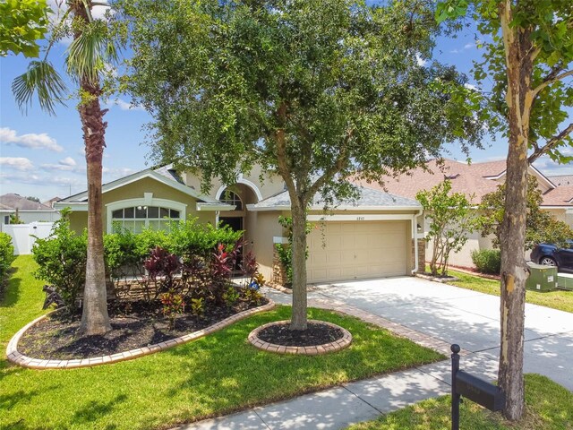 view of front of property featuring a garage and a front lawn