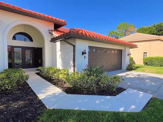 view of front of property featuring a garage and french doors