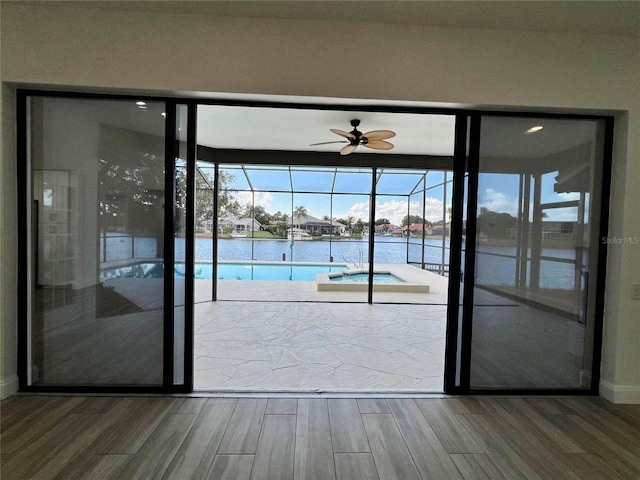 doorway featuring ceiling fan and a water view