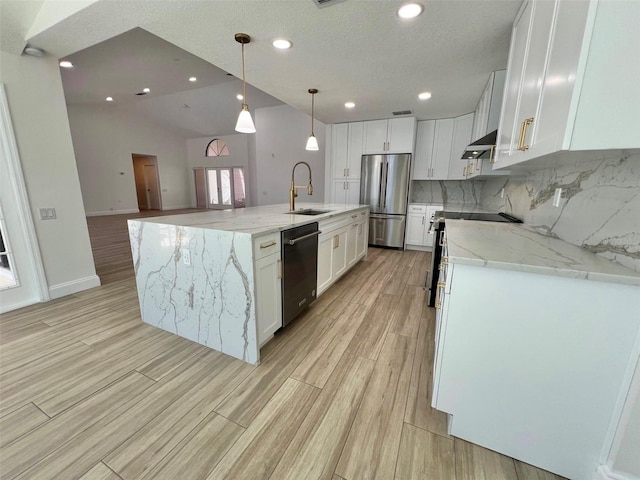 kitchen featuring decorative backsplash, white cabinets, appliances with stainless steel finishes, and sink