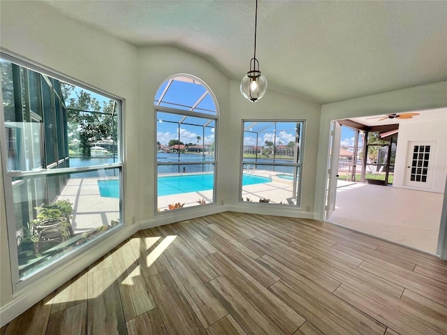 unfurnished sunroom featuring ceiling fan and lofted ceiling