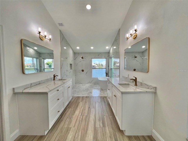 bathroom with vanity and a tile shower