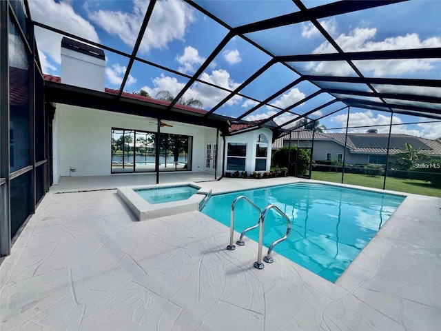 view of swimming pool with an in ground hot tub, a lanai, and a patio