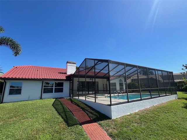 view of pool featuring a yard, a patio, and glass enclosure