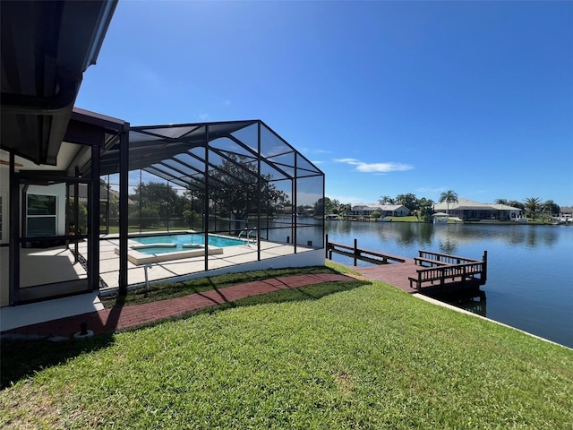 exterior space with glass enclosure, a swimming pool with hot tub, a yard, a water view, and a patio