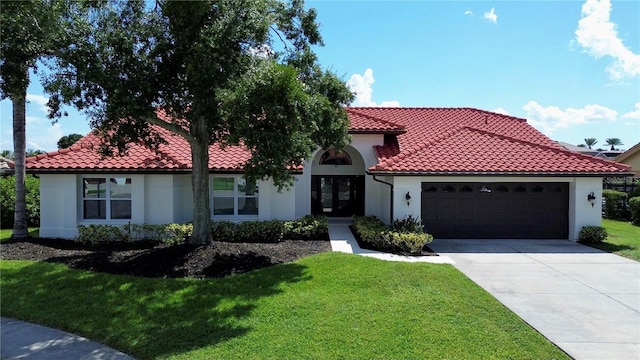 mediterranean / spanish-style house with a front lawn and a garage