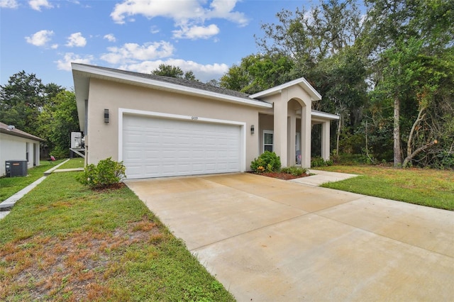 view of front facade with a garage, a front yard, and cooling unit