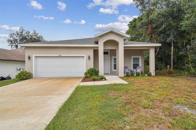 view of front of home with a garage and a front lawn