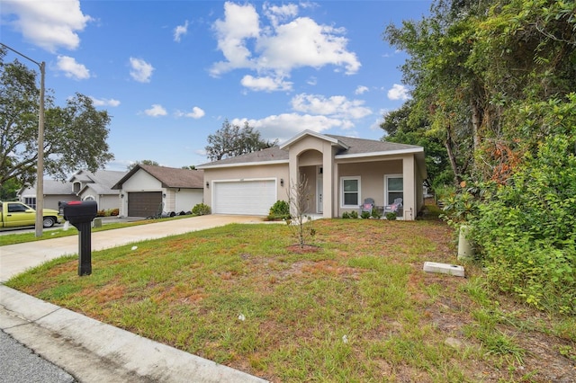 view of front of property featuring an attached garage, a front yard, concrete driveway, and stucco siding