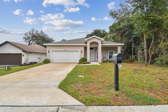 view of front of property with driveway, a front yard, an attached garage, and stucco siding