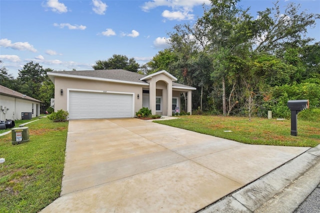 view of front of house with concrete driveway, a front lawn, and stucco siding