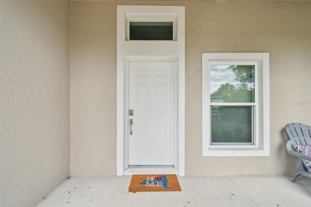 property entrance with stucco siding