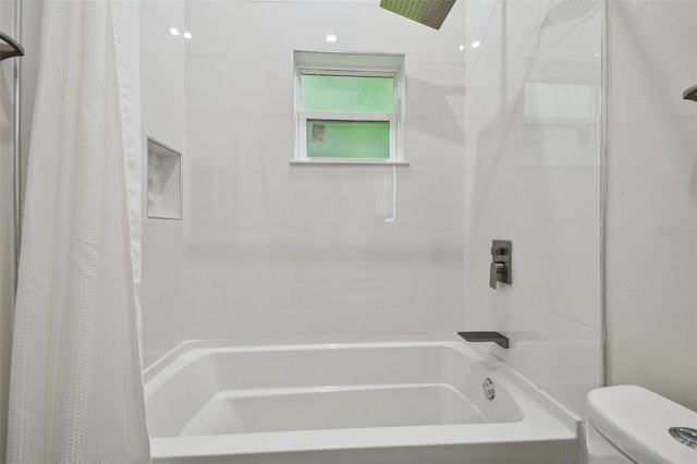 bathroom with shower / bath combination with curtain and toilet