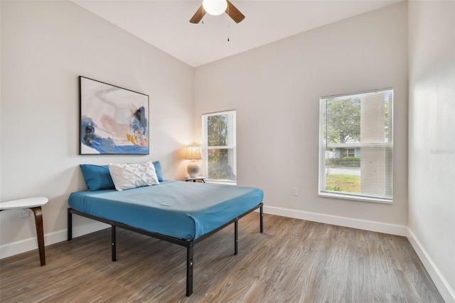 interior space with ceiling fan, baseboards, and wood finished floors