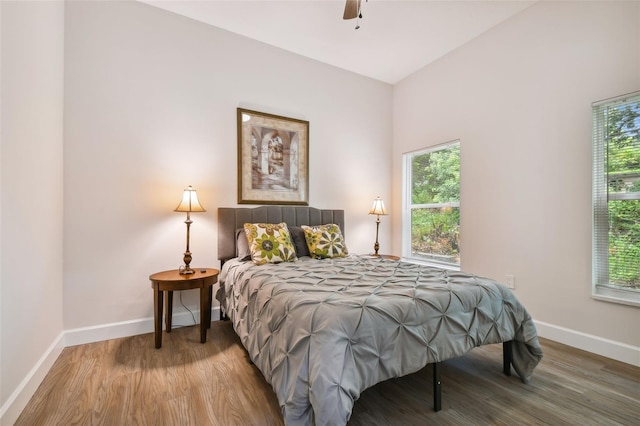 bedroom with baseboards and wood finished floors