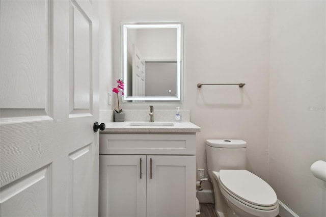 bathroom featuring vanity and toilet