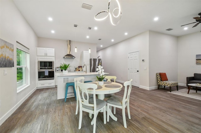 dining room with baseboards, dark wood-type flooring, visible vents, and recessed lighting