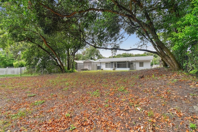 exterior space featuring a sunroom and fence