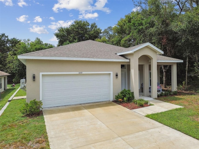 view of front facade with a shingled roof, concrete driveway, stucco siding, an attached garage, and a front yard