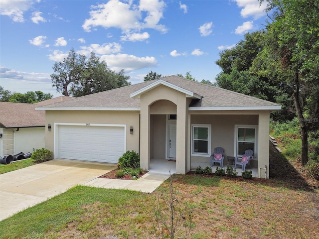 ranch-style home featuring a garage, covered porch, concrete driveway, and stucco siding