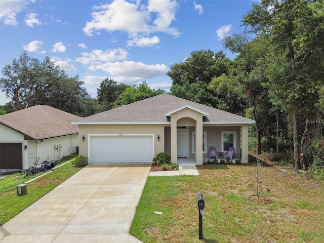 ranch-style home featuring driveway, roof with shingles, an attached garage, a front lawn, and stucco siding