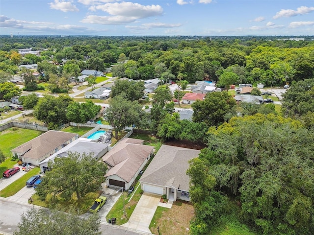 aerial view with a wooded view and a residential view