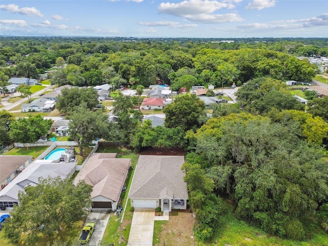 birds eye view of property featuring a residential view and a wooded view