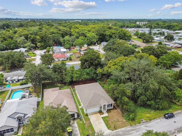 birds eye view of property featuring a residential view and a view of trees