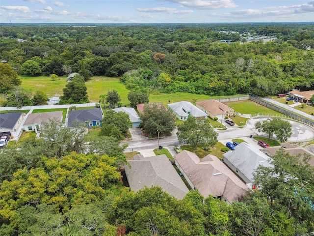 birds eye view of property with a forest view and a residential view