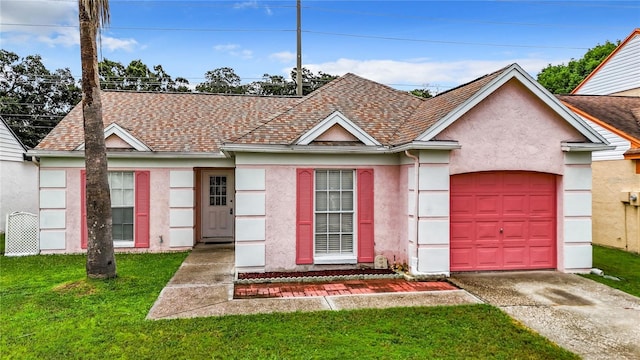 ranch-style home with a front yard, roof with shingles, and stucco siding