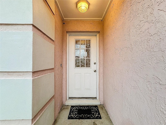 property entrance featuring stucco siding