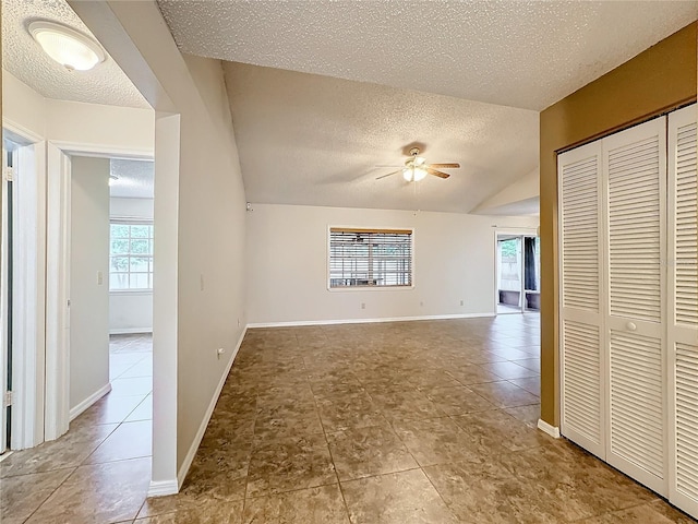 interior space featuring baseboards, a textured ceiling, and tile patterned floors