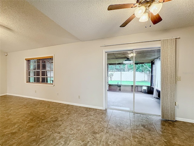 unfurnished room with a textured ceiling, ceiling fan, and baseboards