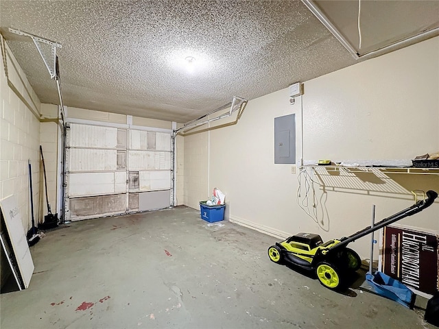 garage featuring concrete block wall and electric panel