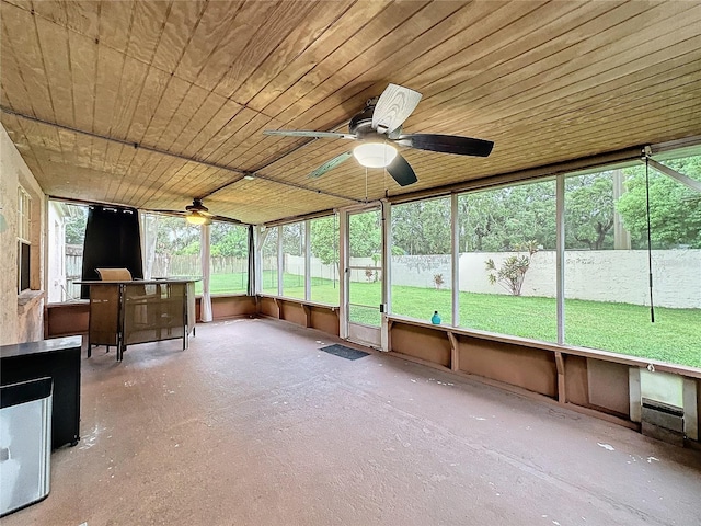 unfurnished sunroom featuring wooden ceiling and ceiling fan