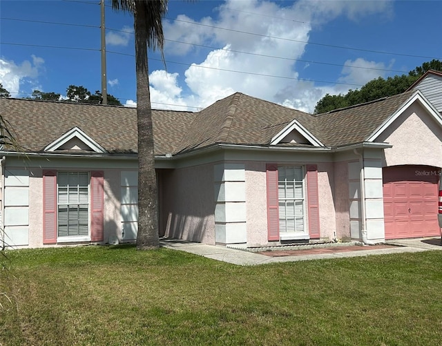 single story home with stucco siding, a shingled roof, and a front yard