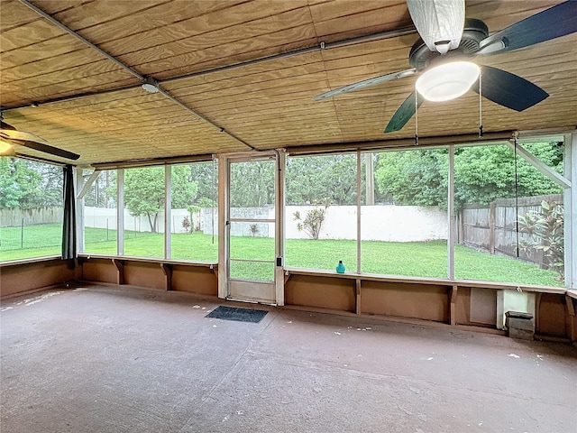 unfurnished sunroom featuring ceiling fan and wood ceiling