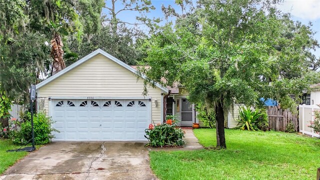 view of front of home with a garage and a front yard