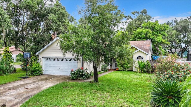 view of front facade with a garage and a front lawn