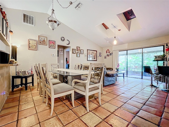 dining room featuring high vaulted ceiling, a skylight, and visible vents