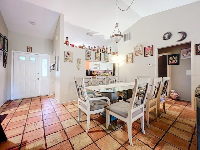 dining room with lofted ceiling and visible vents