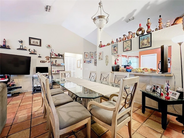 dining area with lofted ceiling and visible vents