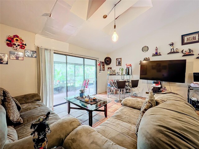 living area featuring vaulted ceiling and light tile patterned flooring