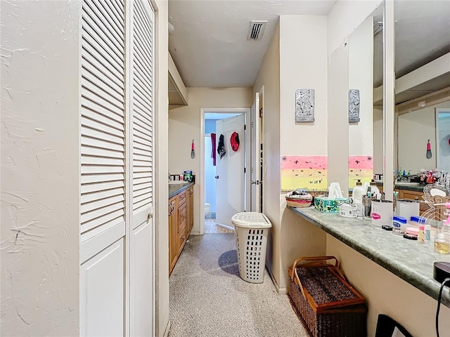 interior space featuring visible vents and a textured wall