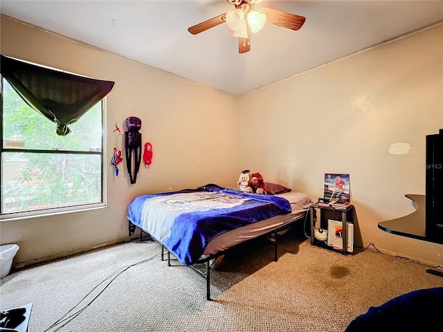 bedroom with ceiling fan and carpet