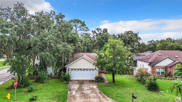 view of front of home featuring a garage, driveway, and a front yard